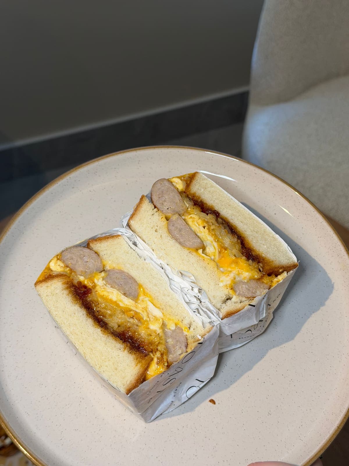 TOAST & Co brunch sandwich with sausage, scrambled omelette and cheese on house bloomer bread